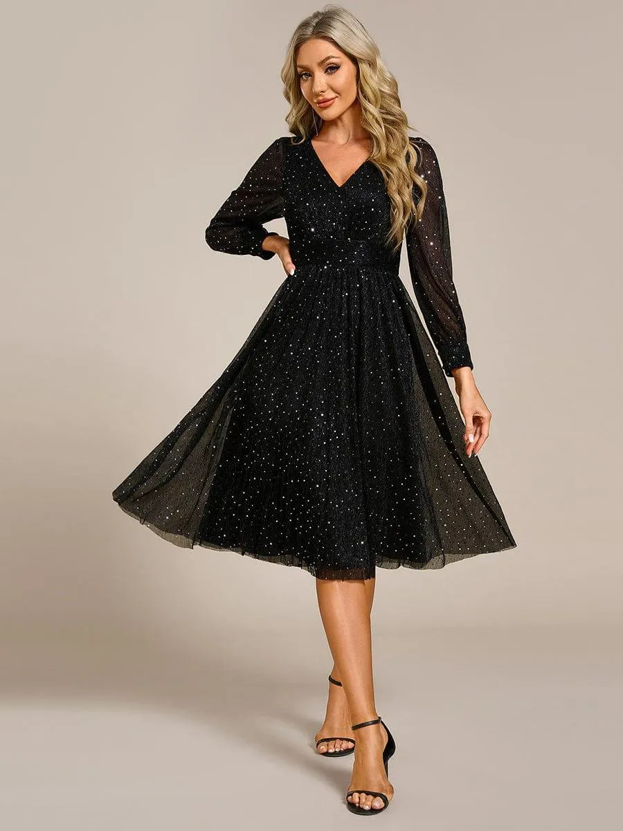 Robe de mariée mi-longue pailletée à manches longues